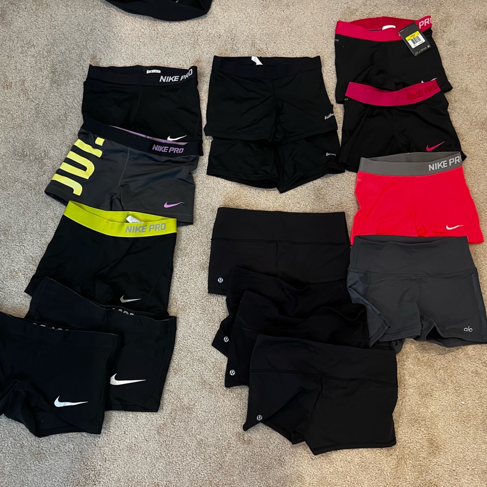 Bundle of 15 spandex shorts (Lululemon, Nike, Alo, EastBay). Most worn, one NWT.